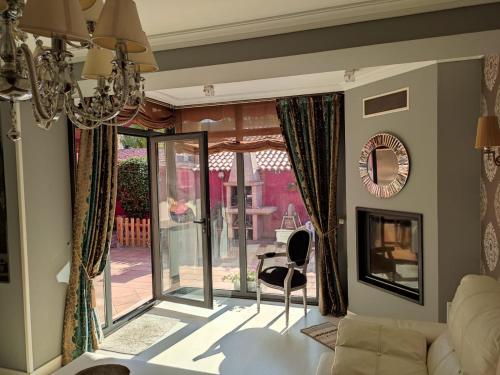 a living room with a chandelier and sliding glass doors at Casa Marina in Ribeira