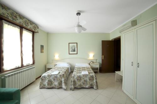 Säng eller sängar i ett rum på Albergo Il Gufo
