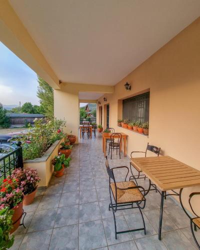 a patio with a wooden table and chairs at Hotel Spiridoula in Kleidonia