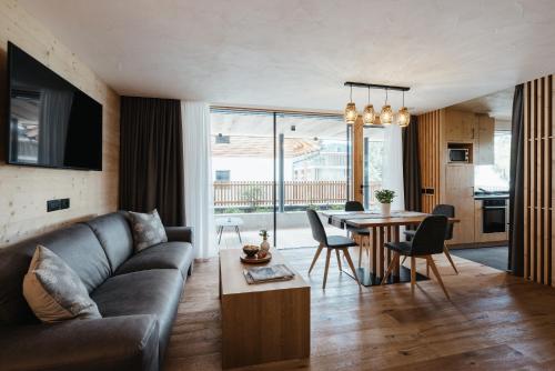 a living room with a couch and a table at Chalet Dolecir in La Valle