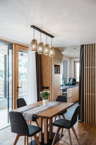 a kitchen and dining room with a table and chairs at Chalet Dolecir in La Valle