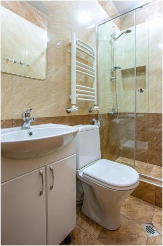 a bathroom with a toilet and a sink and a shower at Arma Boutique Hotel in Yerevan