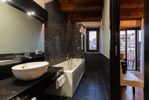 a bathroom with a tub and a sink and a bath tub at Gratteri Resort in Gratteri