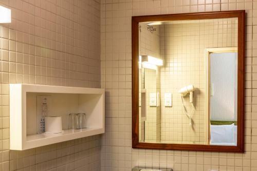 a bathroom with a mirror and a sink at Hotel A.S. Lisboa in Lisbon