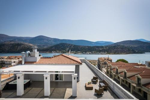 a balcony with a view of the water and buildings at Aenos Hotel in Argostoli