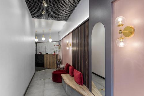 a hallway with red chairs in a room at Renome Hotel in Saint Petersburg