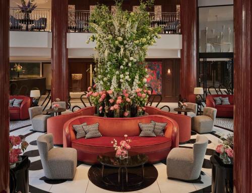 
a living room filled with couches and tables at One Aldwych in London
