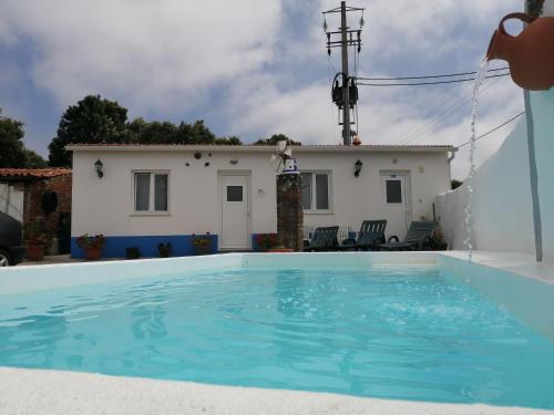 a villa with a swimming pool in front of a house at Casa da Paraventa in Gaieiras