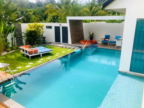 a swimming pool in the middle of a villa at Villa MAI MEE PAN HA 3 bedrooms in Nai Yang Beach