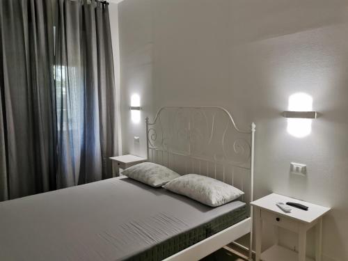 a bed with two pillows on it in a room at La Rosa Casa Vacanze Sabaudia in Sabaudia