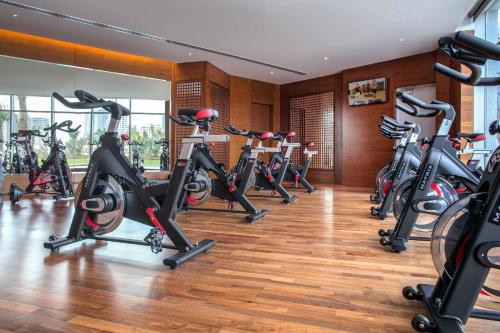 a row of exercise bikes in a gym at The Art Hotel & Resort in Manama