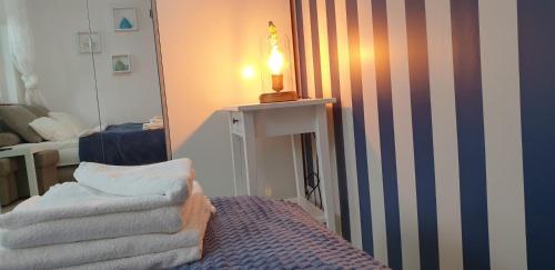 a room with a mirror and a chair and a lamp at Dom Przy Plaży in Sarbinowo