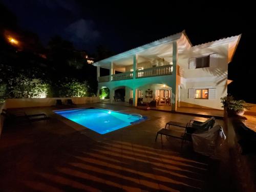 una casa grande con piscina por la noche en Exclusive Poolvilla Patricia - Camp de Mar, en Andratx