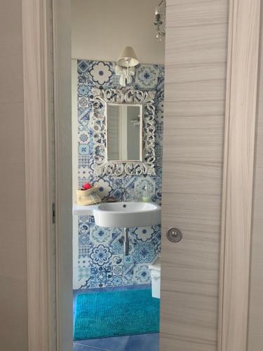 a bathroom with a sink and a mirror at Camera matrimoniale LA LAMPUGA in Marettimo