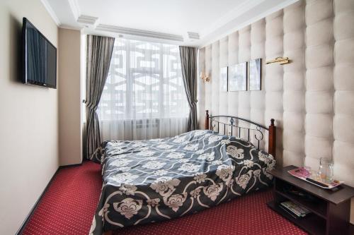 a bedroom with a bed and a large window at Express Hotel&Hostel in Kazan