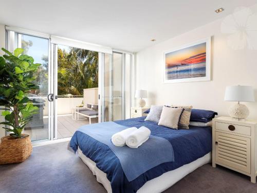 En eller flere senge i et værelse på Bennetts by the Beach