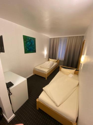 a hotel room with two beds and a window at Luise City - An der Philharmonie in Essen