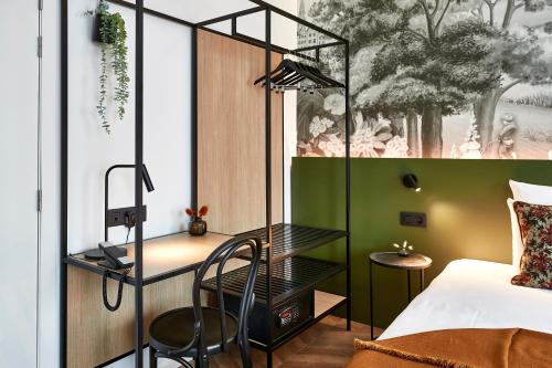 a bedroom with a bed and a desk and a chair at Urban Yard Hotel in Brussels