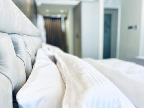 a close up of a bed with white sheets at Casa Reale Boutique Hotel in Valletta
