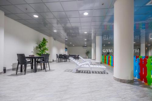 a dining room with chairs and tables in a building at The Address Palace Apartments in Dammam