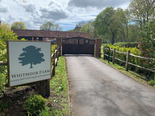 a gate to a house with a sign in front of it at Whitmoor Farm & Spa in Guildford