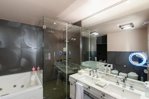 a bathroom with two sinks and a large mirror at Hotel Number Nine in Florence