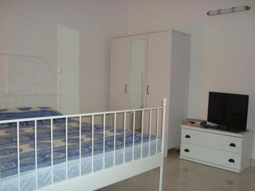 een slaapkamer met een wieg en een tv op een dressoir bij Apartment SEA STAR in Hvar