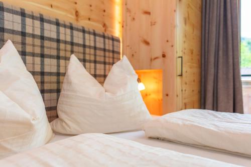 a bedroom with two white pillows on a bed at Apartment Gästehaus Luggau in Rauris