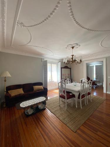 a living room with a table and a couch at Palacete Plaza Mayor in El Burgo de Osma