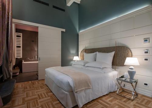a bedroom with a large bed and a bathroom at Hotel Number Nine in Florence