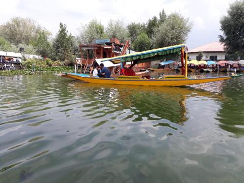 a group of people riding a boat on the water at Houseboats Jackson Heights in Srinagar