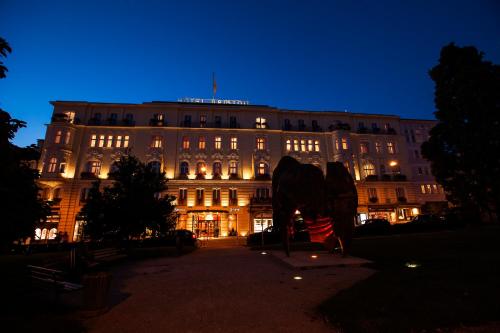 a large building with a large elephant statue in front of it at Hotel Bristol Salzburg in Salzburg
