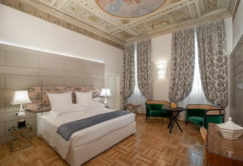 a bedroom with a large bed and a coffered ceiling at Hotel Number Nine in Florence