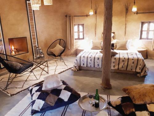 a large room with a bed and a fireplace at Fawakay Villas in Sfiani