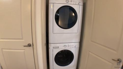 a white washer and dryer sitting next to a door at National at Clarendon in Arlington
