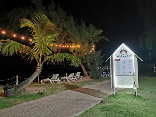 a sign in front of a beach at night at Casa Grande Hotel Restaurant in Las Terrenas