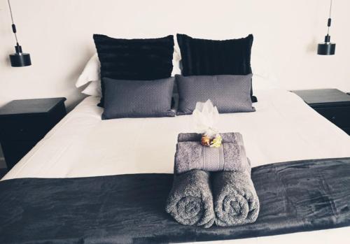 a bedroom with a bed with towels on it at Jordan's Break in Jeffreys Bay