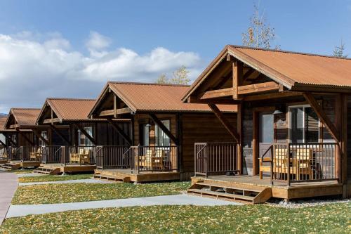 a row of log cabins in a row at Teton Valley Resort in Victor