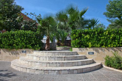 a set of concrete steps with trees and bushes at Villa Musica in Sannicola