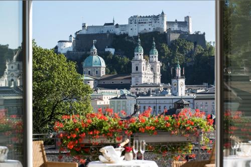 a view of a city with a castle in the background at Hotel Bristol Salzburg in Salzburg