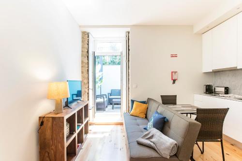 a living room with a couch and a table at Central Studio with Pool & Patio by LovelyStay in Porto