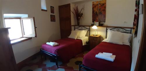 a small room with two beds and a window at Legacy Scanno in Scanno