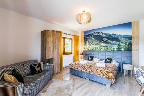 a bedroom with a bed and a couch at Dom Wczasowy Tatrzański in Szaflary
