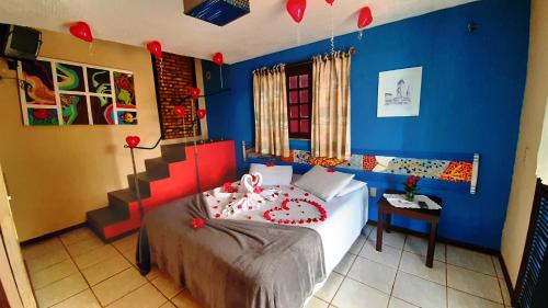 1 dormitorio con cama y pared azul en Hotel O Alemão en Mulungu