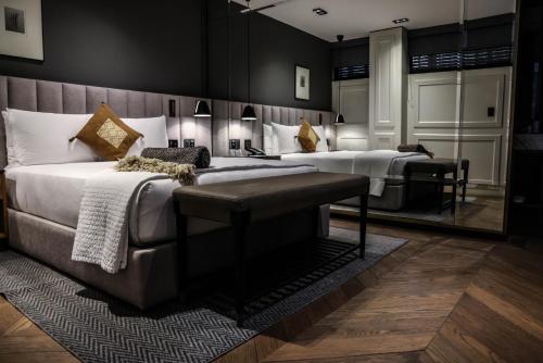 a hotel room with two beds and a mirror at Brick Hotel Mexico City - Small Luxury Hotels of the World in Mexico City