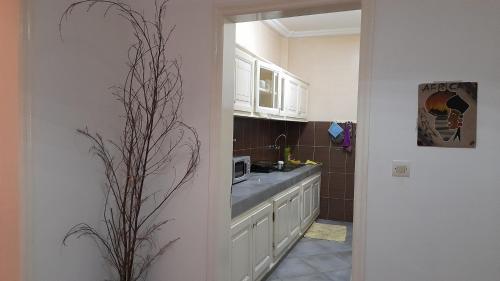 a kitchen with a sink and a microwave at Nalabba in Dakar
