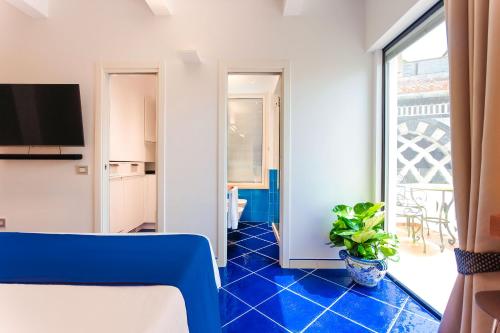 a living room with a blue tile floor at La Suite Del Cavaliere in Amalfi