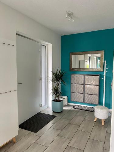 a living room with a blue wall and a window at Ferienwohnung Tanja in Engen
