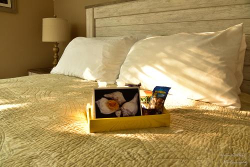 a box of flowers sitting on a bed at The Yellow Rose of Talbot Bed and Breakfast in Easton