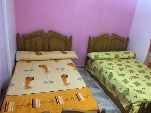 two beds sitting next to each other in a bedroom at AC, Wi-Fi Panorama View Shahrazad Beach Apartment in Alexandria